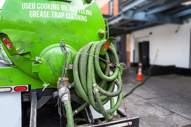 a vacuum truck pumping out a large underground grease trap in Dale, WI